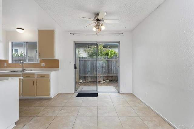 1608 Grandview St, Oceanside, CA 92054 - kitchen featuring light countertops, a textured ceiling, ceiling fan, light tile patterned floors, and cream cabinetry