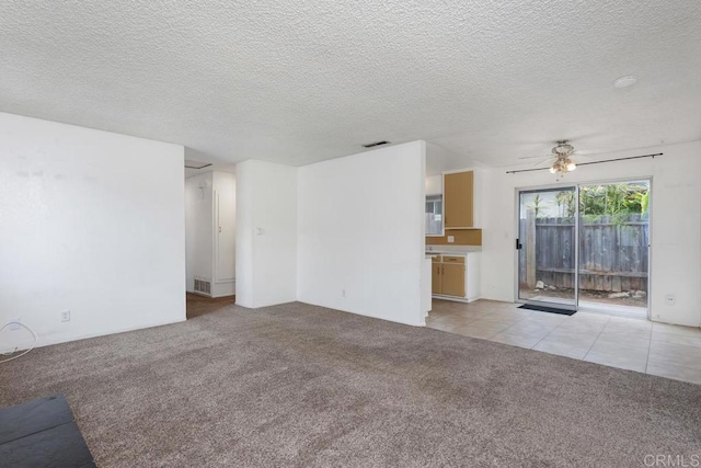 1608 Grandview St, Oceanside, CA 92054 - unfurnished living room featuring light colored carpet, a ceiling fan, light tile patterned floors, and a textured ceiling