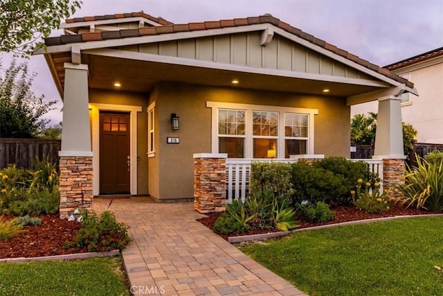 316 Junipero Way, San Luis Obispo, CA 93401 - view of front facade with covered porch, stone siding, stucco siding, and a tiled roof