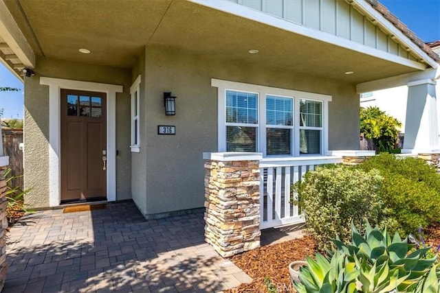 316 Junipero Way, San Luis Obispo, CA 93401 - doorway to property with stucco siding, covered porch, and board and batten siding