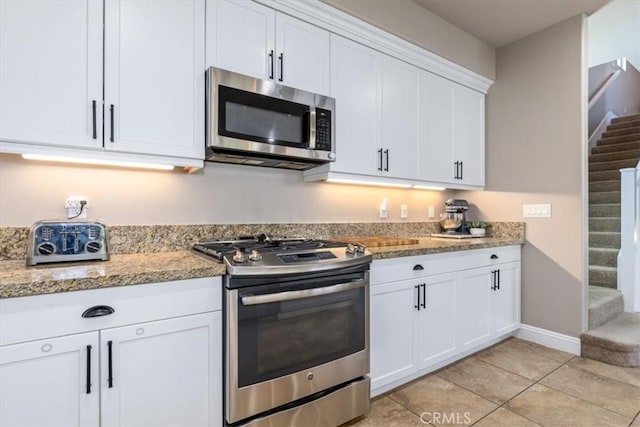 316 Junipero Way, San Luis Obispo, CA 93401 - kitchen featuring stainless steel appliances, white cabinetry, light tile patterned floors, and light stone countertops