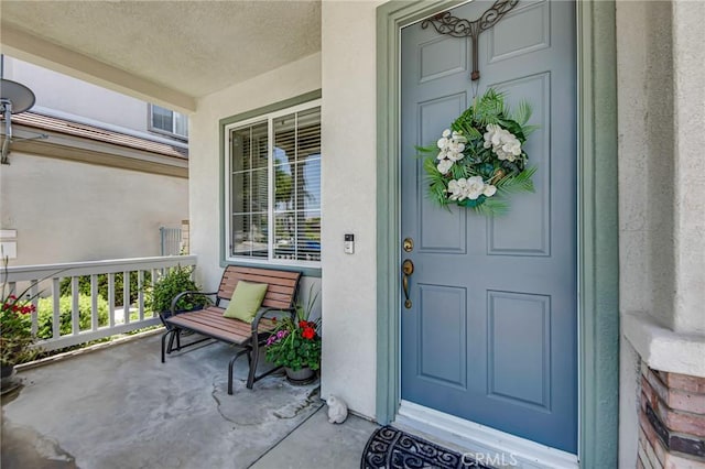 28089 Promontory Ln, Valencia, CA 91354 - doorway to property with covered porch and stucco siding