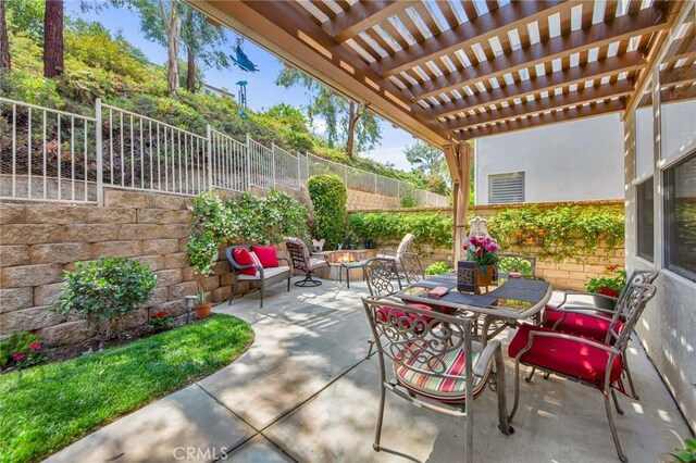 28089 Promontory Ln, Valencia, CA 91354 - fenced backyard featuring a patio, outdoor dining space, an outdoor fire pit, and a pergola