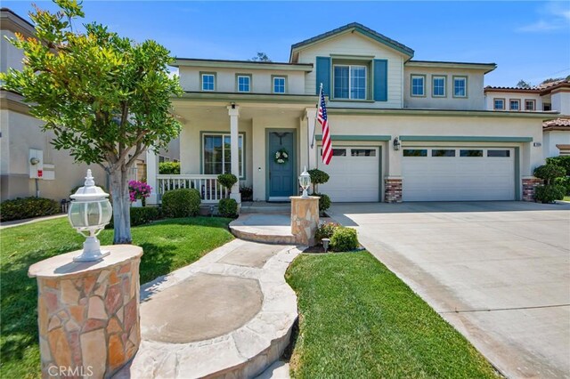 28089 Promontory Ln, Valencia, CA 91354 - view of front facade with stucco siding, a porch, a garage, concrete driveway, and a front lawn