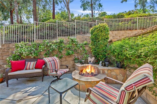 28089 Promontory Ln, Valencia, CA 91354 - fenced backyard featuring a patio and an outdoor fire pit
