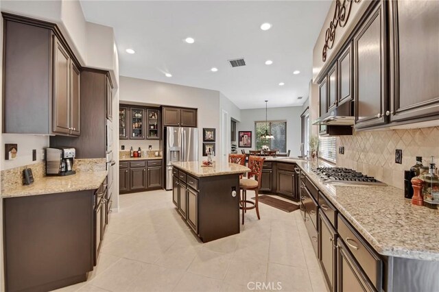 28089 Promontory Ln, Valencia, CA 91354 - kitchen featuring stainless steel appliances, under cabinet range hood, recessed lighting, backsplash, and a center island