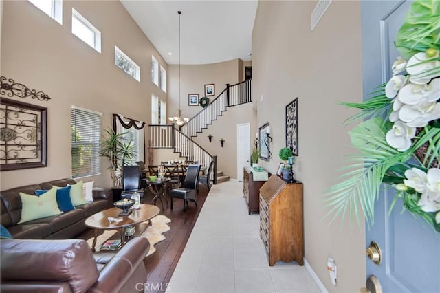 28089 Promontory Ln, Valencia, CA 91354 - living room featuring stairway, a high ceiling, and light wood-type flooring