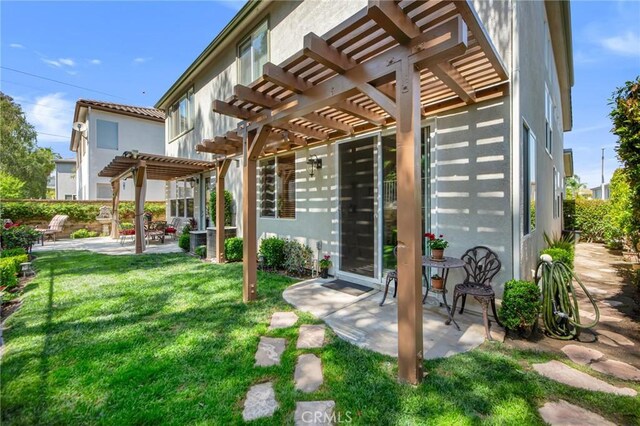 28089 Promontory Ln, Valencia, CA 91354 - rear view of house featuring a pergola, a patio, a lawn, and stucco siding