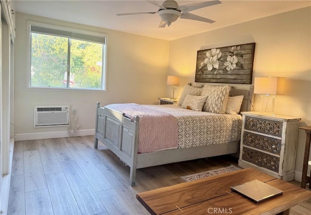 2148 Ronda Granada Unit A, Laguna Woods, CA 92637 - bedroom with a wall mounted AC, wood-type flooring, and a ceiling fan