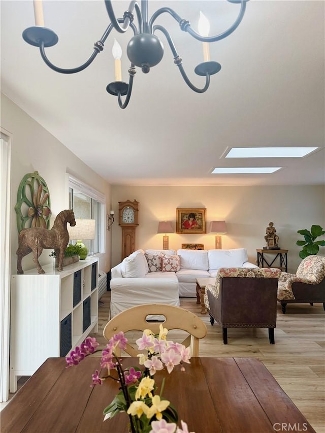2148 Ronda Granada Unit A, Laguna Woods, CA 92637 - living room featuring a skylight and light wood-type flooring