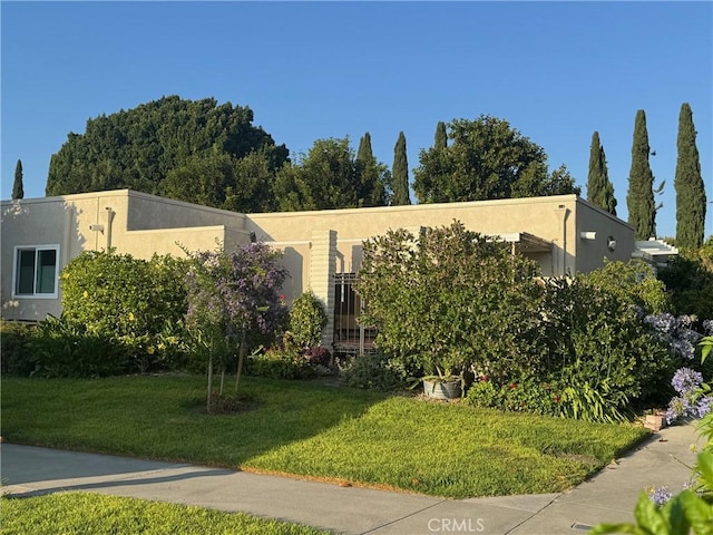 2148 Ronda Granada Unit A, Laguna Woods, CA 92637 - view of front of home featuring stucco siding and a front lawn