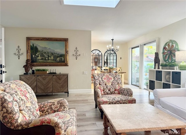 2148 Ronda Granada Unit A, Laguna Woods, CA 92637 - living room with a chandelier, light wood-style floors, and a skylight