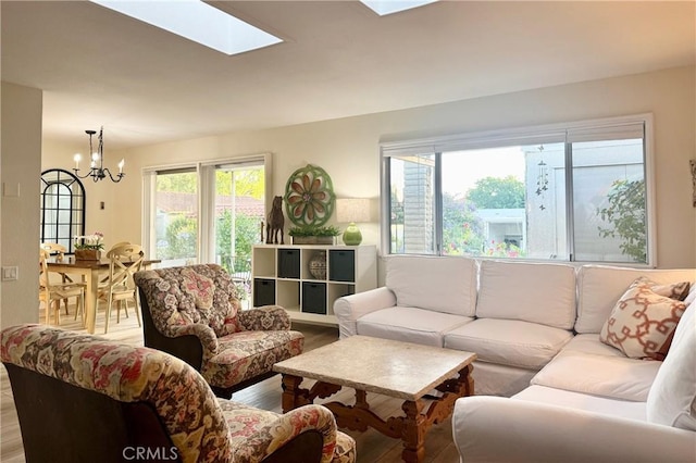 2148 Ronda Granada Unit A, Laguna Woods, CA 92637 - living area featuring a chandelier, light wood-type flooring, and a skylight