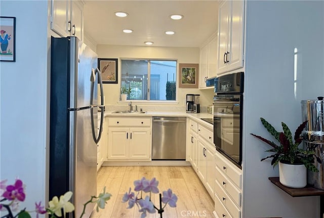 2148 Ronda Granada Unit A, Laguna Woods, CA 92637 - kitchen featuring appliances with stainless steel finishes, white cabinets, light countertops, light wood-style flooring, and recessed lighting