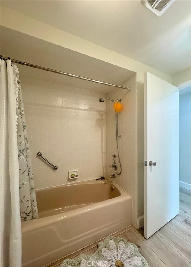 2148 Ronda Granada Unit A, Laguna Woods, CA 92637 - bathroom featuring shower / tub combo with curtain and wood finished floors