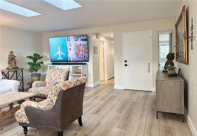 2148 Ronda Granada Unit A, Laguna Woods, CA 92637 - living room with light wood finished floors and a skylight