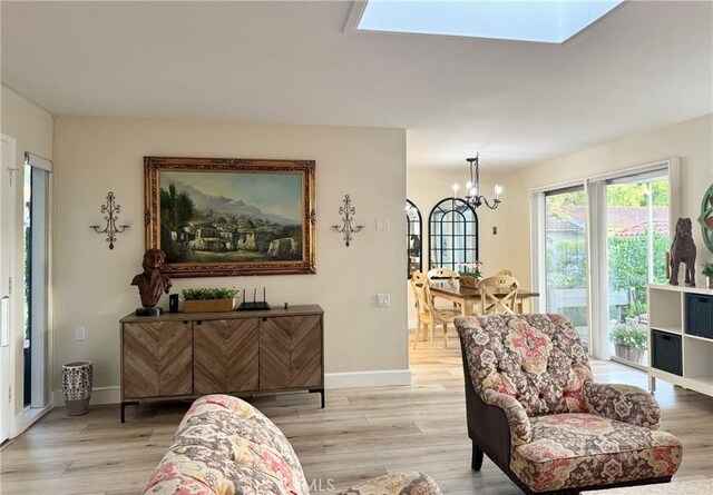 2148 Ronda Granada Unit A, Laguna Woods, CA 92637 - living area with a chandelier, light wood-style floors, and a skylight