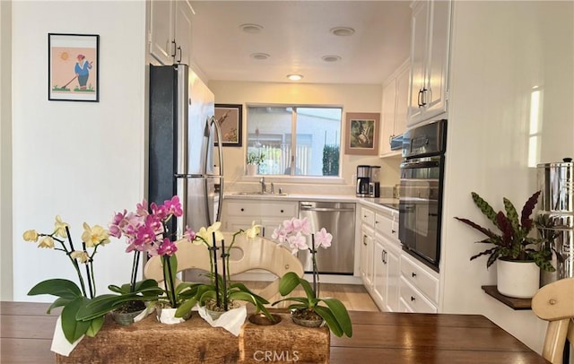 2148 Ronda Granada Unit A, Laguna Woods, CA 92637 - kitchen featuring stainless steel appliances, white cabinets, and light countertops