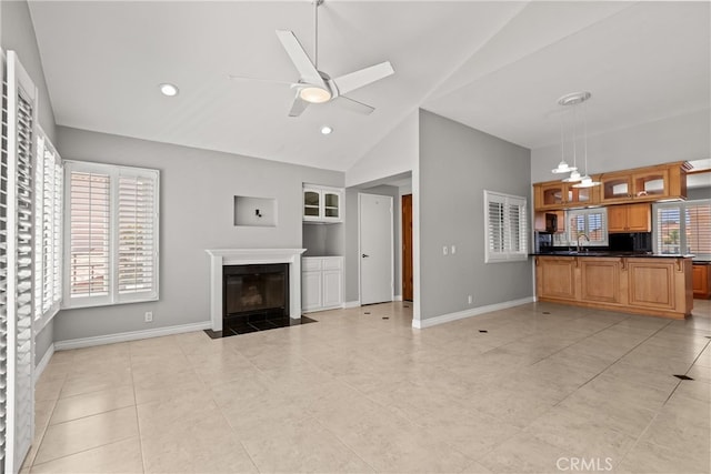 3211 Anne Cir Unit Ci102, Huntington Beach, CA 92649 - unfurnished living room with built in shelves, a ceiling fan, a fireplace with flush hearth, high vaulted ceiling, and light tile patterned floors