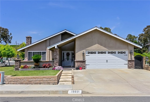 19851 Ridgewood Pl, Yorba Linda, CA 92886 - view of front of property with stucco siding, an attached garage, stone siding, concrete driveway, and a chimney