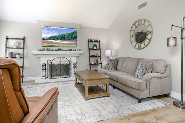 19851 Ridgewood Pl, Yorba Linda, CA 92886 - living area with wood finished floors, vaulted ceiling, and a brick fireplace