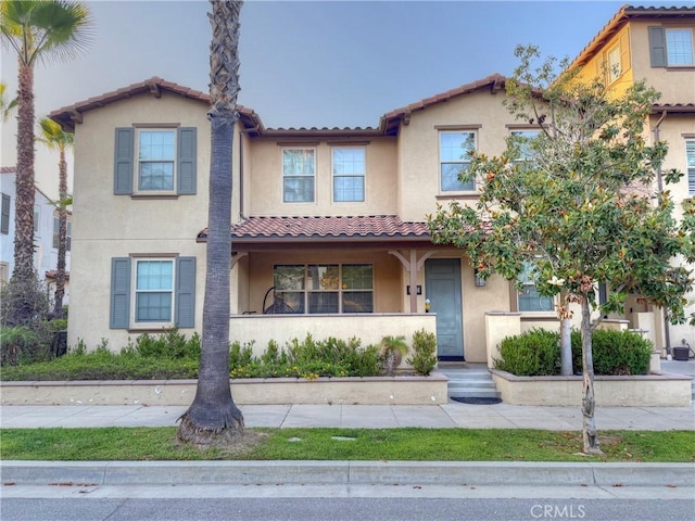 867 E Prommenade Unit B, Azusa, CA 91702 - view of front of house with stucco siding, a tile roof, and a porch
