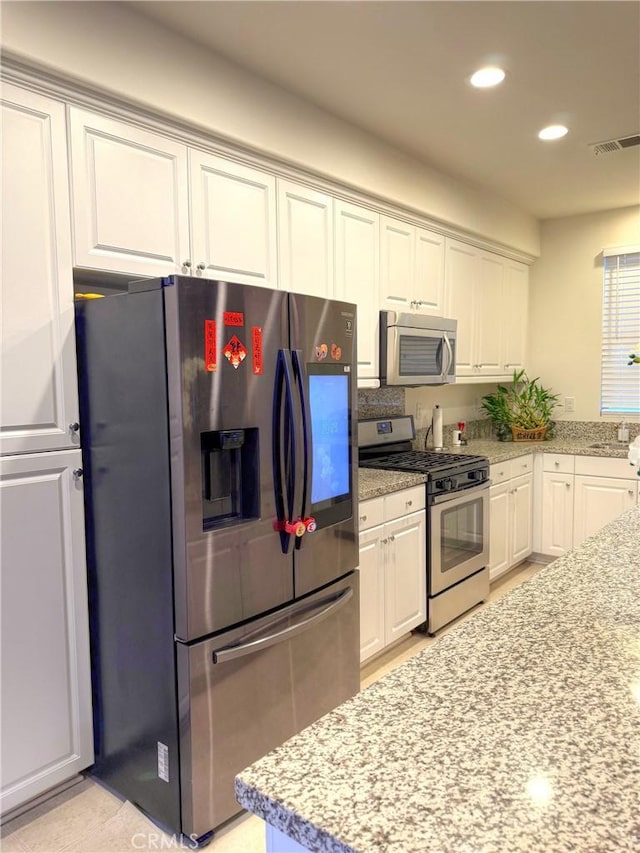 867 E Prommenade Unit B, Azusa, CA 91702 - kitchen with appliances with stainless steel finishes, white cabinets, recessed lighting, and light stone countertops