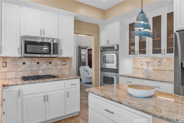 982 Big Spring Ct, Corona, CA 92878 - kitchen featuring stainless steel appliances, white cabinetry, glass insert cabinets, and decorative backsplash