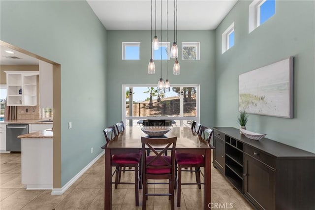 982 Big Spring Ct, Corona, CA 92878 - dining space featuring a towering ceiling, healthy amount of natural light, light tile patterned floors, and a chandelier