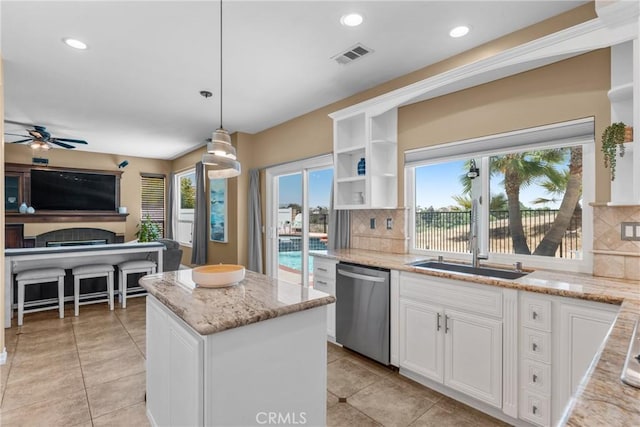 982 Big Spring Ct, Corona, CA 92878 - kitchen featuring dishwasher, light tile patterned floors, backsplash, light stone countertops, and recessed lighting