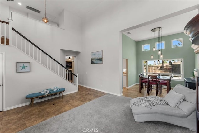 982 Big Spring Ct, Corona, CA 92878 - living room featuring a towering ceiling, stairway, carpet floors, and tile patterned floors