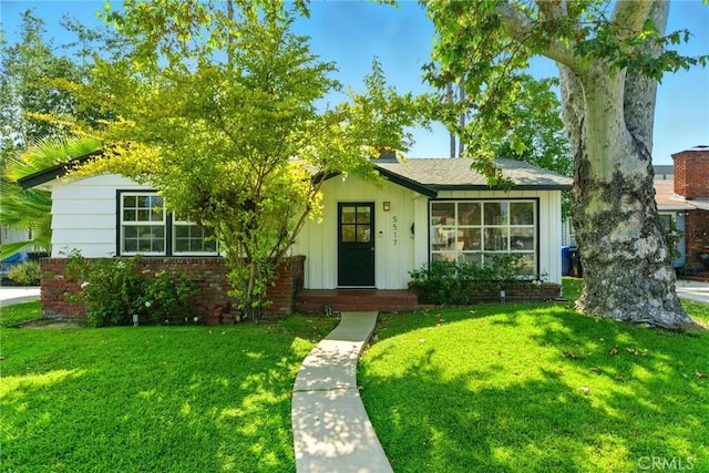 5517 Bevis Ave, Sherman Oaks, CA 91411 - view of front of property with board and batten siding, a front lawn, and brick siding