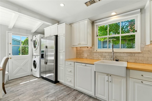 5517 Bevis Ave, Sherman Oaks, CA 91411 - laundry room featuring estacked washer and dryer, light wood-style floors, and recessed lighting