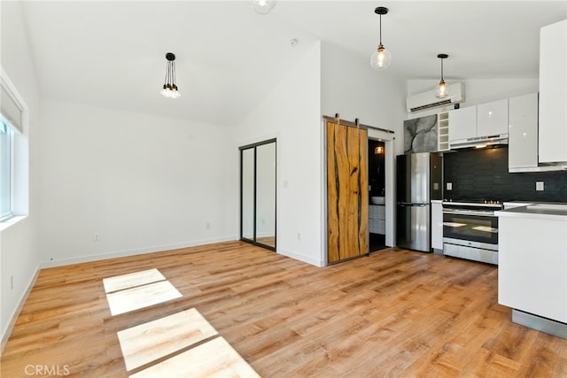 5517 Bevis Ave, Sherman Oaks, CA 91411 - kitchen with a wall mounted air conditioner, white cabinets, stainless steel appliances, pendant lighting, and under cabinet range hood