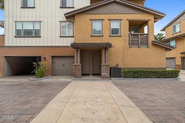 1430 Windshore Way, Oxnard, CA 93035 - view of front of house with board and batten siding, decorative driveway, an attached garage, and a balcony