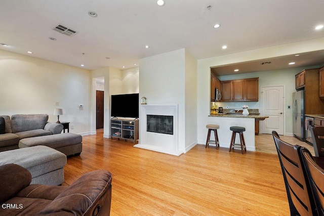 1430 Windshore Way, Oxnard, CA 93035 - living room with light wood-style floors, recessed lighting, and a glass covered fireplace