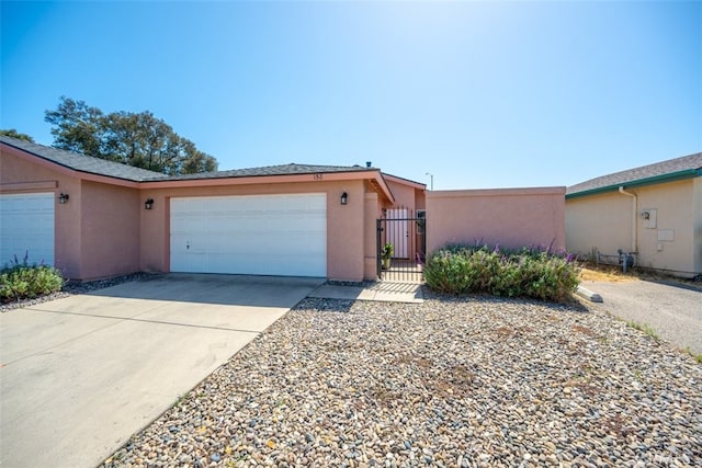 158 Colt Ln, Nipomo, CA 93444 - ranch-style house featuring a garage, stucco siding, concrete driveway, and a gate
