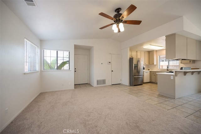 158 Colt Ln, Nipomo, CA 93444 - kitchen with stainless steel fridge, a peninsula, light countertops, a ceiling fan, and a breakfast bar area