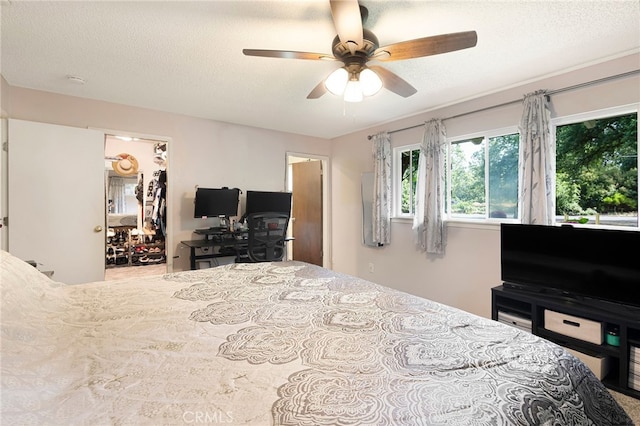 1915 Manzanita Ave, Chico, CA 95926 - bedroom with a walk in closet, a textured ceiling, an office area, ceiling fan, and a closet