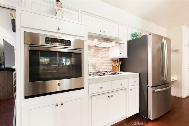 1915 Manzanita Ave, Chico, CA 95926 - kitchen featuring stainless steel appliances, backsplash, dark wood-style floors, light countertops, and white cabinetry