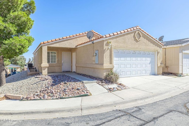 2400 Sunset Ridge Dr, Rosamond, CA 93560 - view of front of property featuring a garage, stucco siding, driveway, and a tiled roof