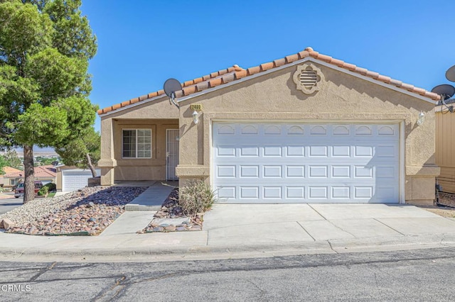 2400 Sunset Ridge Dr, Rosamond, CA 93560 - view of front of home featuring stucco siding, an attached garage, concrete driveway, and a tiled roof