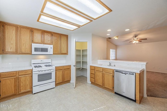2400 Sunset Ridge Dr, Rosamond, CA 93560 - kitchen featuring white appliances, a peninsula, a ceiling fan, tile countertops, and recessed lighting