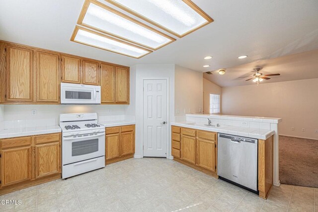 2400 Sunset Ridge Dr, Rosamond, CA 93560 - kitchen featuring white appliances, a peninsula, a ceiling fan, tile countertops, and open floor plan