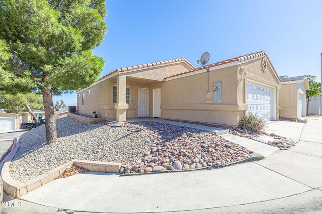 2400 Sunset Ridge Dr, Rosamond, CA 93560 - view of front of property with an attached garage, stucco siding, and a tile roof