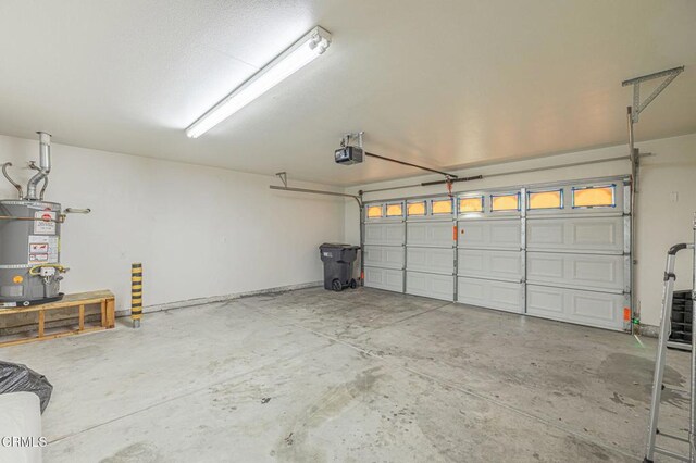 2400 Sunset Ridge Dr, Rosamond, CA 93560 - garage with strapped water heater and a garage door opener
