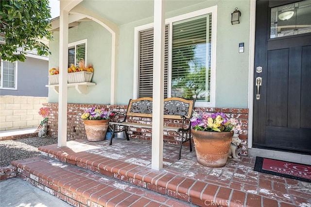 16128 Haldane St, Whittier, CA 90603 - doorway to property with covered porch and stucco siding