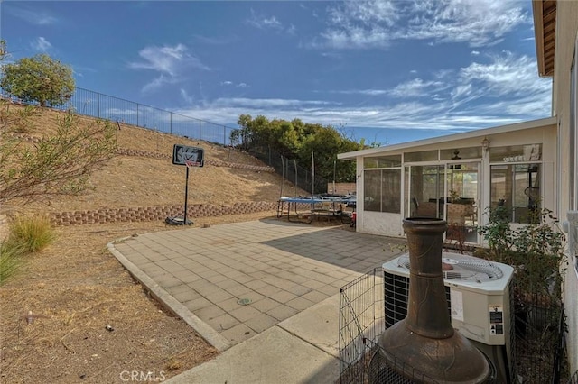 13524 Via Santa Catalina, Sylmar, CA 91342 - fenced backyard featuring a trampoline, a sunroom, and a patio