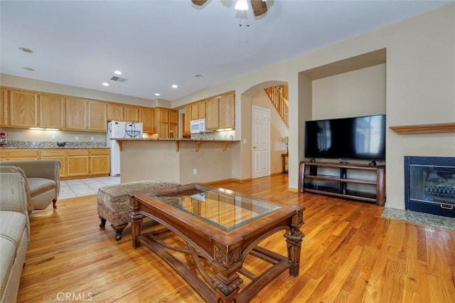 13524 Via Santa Catalina, Sylmar, CA 91342 - living room featuring arched walkways, recessed lighting, a ceiling fan, light wood-style floors, and a fireplace with flush hearth