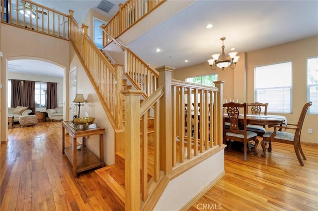 13524 Via Santa Catalina, Sylmar, CA 91342 - stairway featuring arched walkways, wood finished floors, healthy amount of natural light, a chandelier, and recessed lighting
